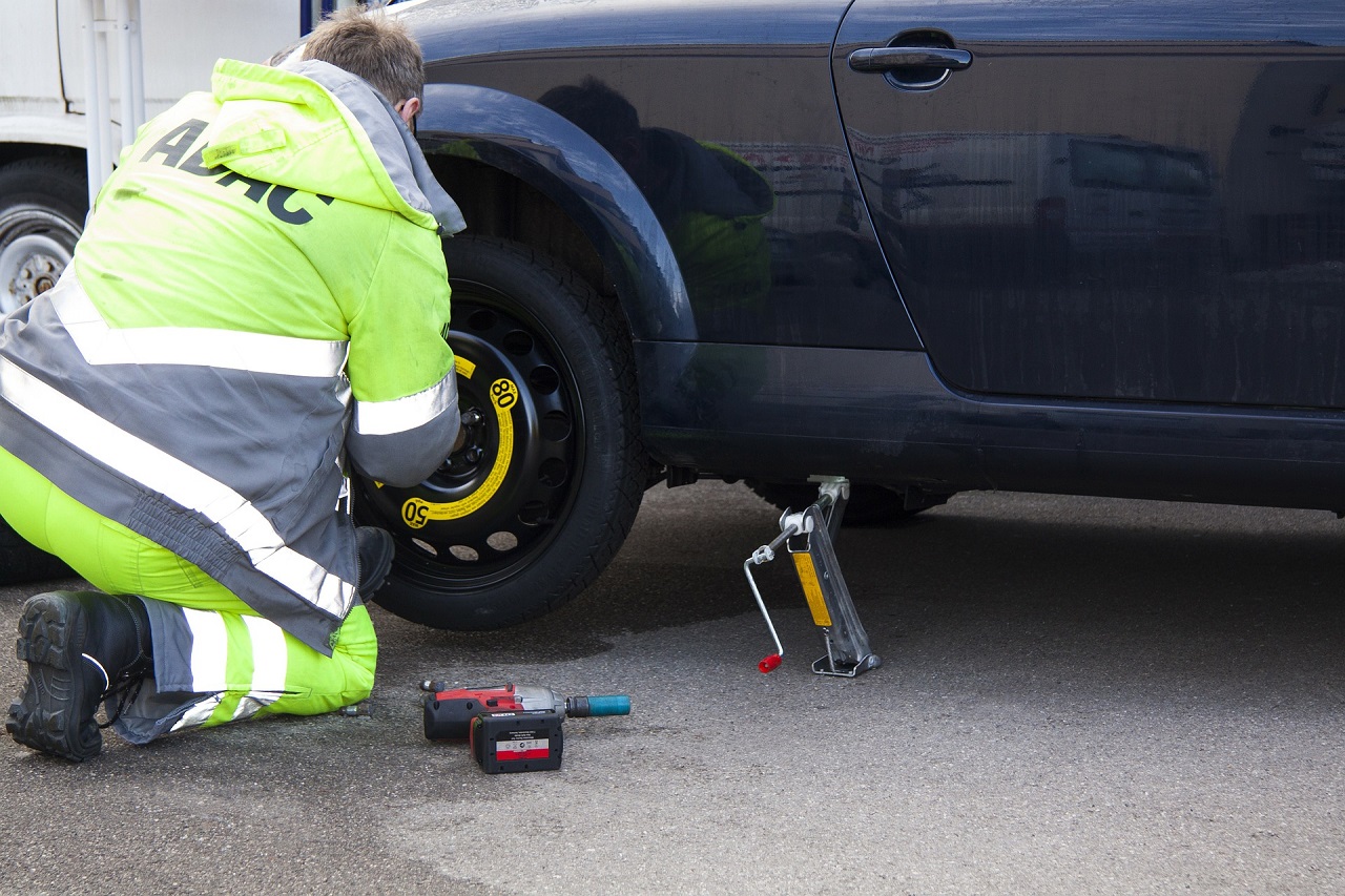 Timber Towing Driver Performing Flat Tire Service