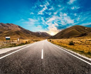 Picturesque landscape scene and sunrise above road